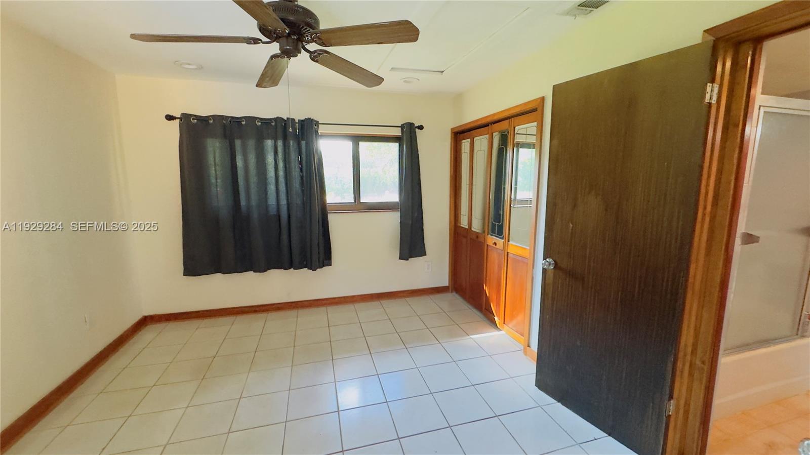 18350 Southwest 214th Street Miami, FL 33187 - Photo 5 of 24 a view of an empty room with a window