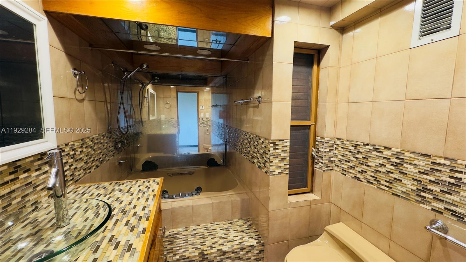 18350 Southwest 214th Street Miami, FL 33187 - Photo 10 of 24 a bathroom with a toilet and a shower