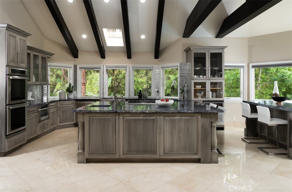 10282 Ambervale Lane North Tustin, CA 92705 - Photo 12 of 41 a kitchen with stainless steel appliances kitchen island granite countertop a stove and cabinets