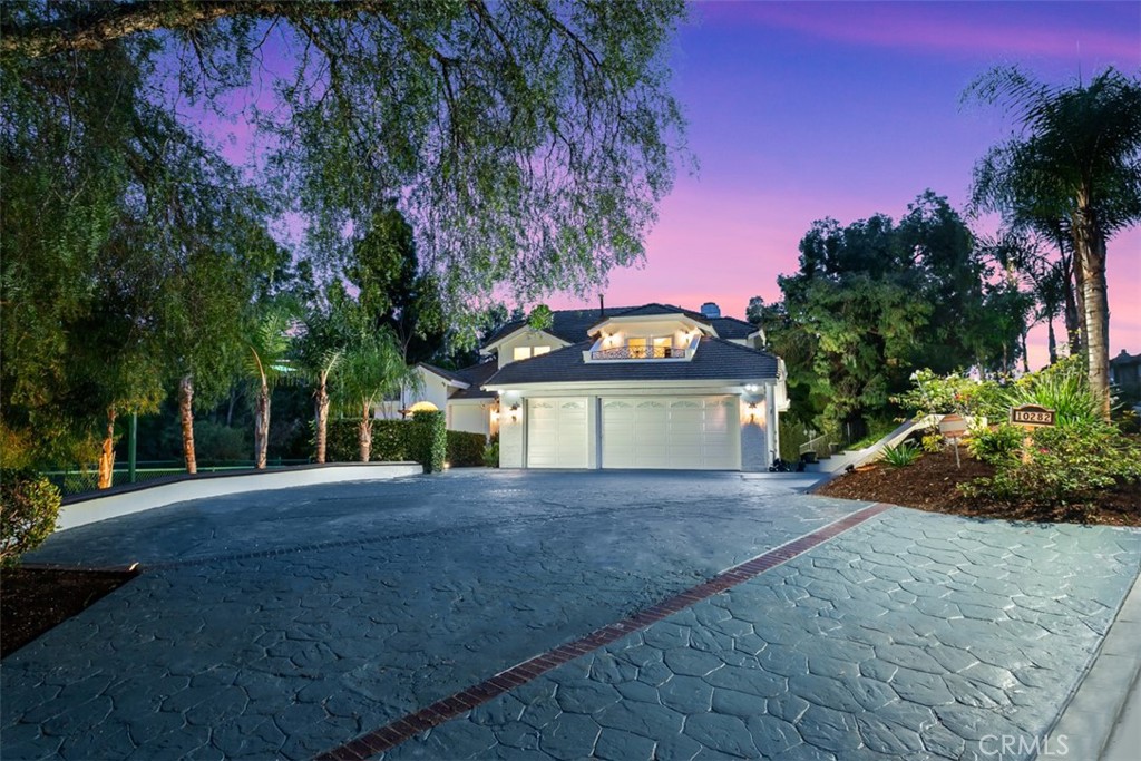 10282 Ambervale Lane North Tustin, CA 92705 - Photo 3 of 41 a view of yellow house with a yard and large trees
