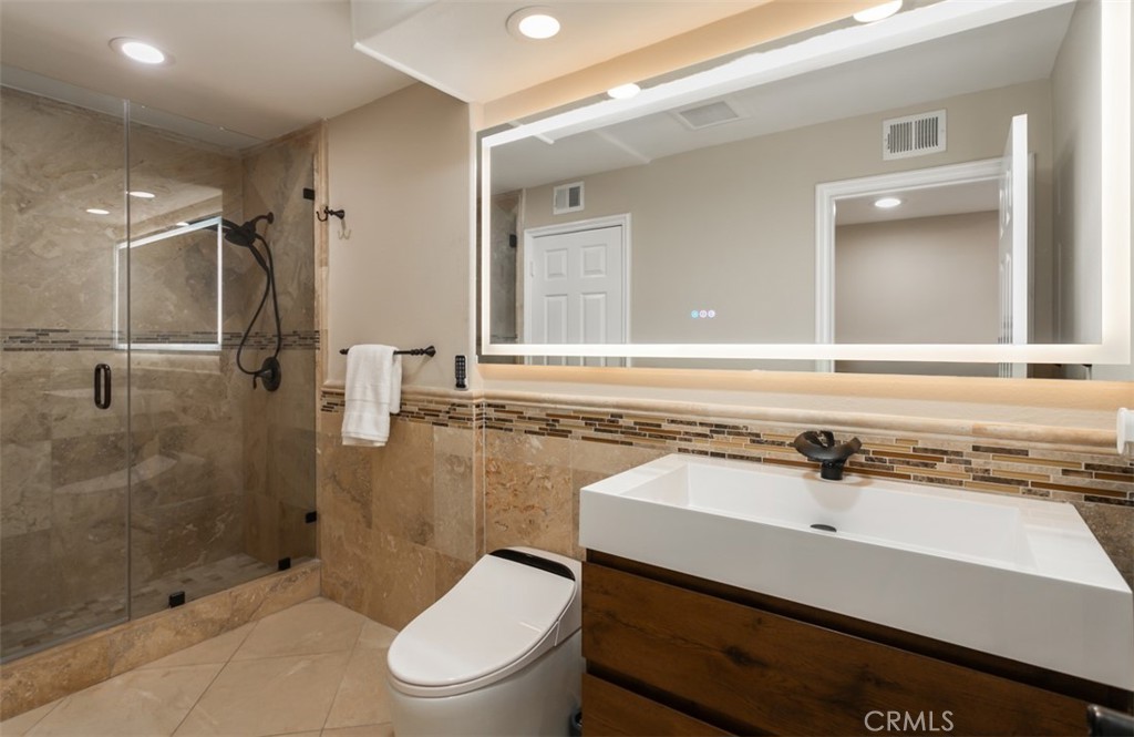 10282 Ambervale Lane North Tustin, CA 92705 - Photo 33 of 41 a bathroom with a sink a toilet and shower