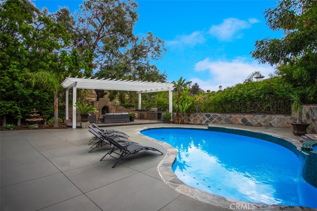 10282 Ambervale Lane North Tustin, CA 92705 - Photo 39 of 41 a view of swimming pool with outdoor seating and a garden