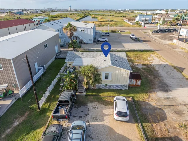 an aerial view of a house with a ocean view
