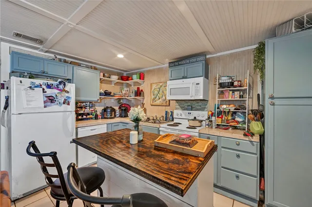 a room with furniture a refrigerator and a table