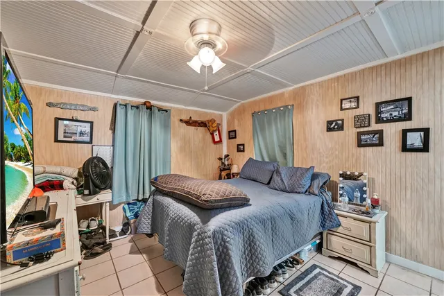 a bedroom with a bed a books bucket with a desk and chair