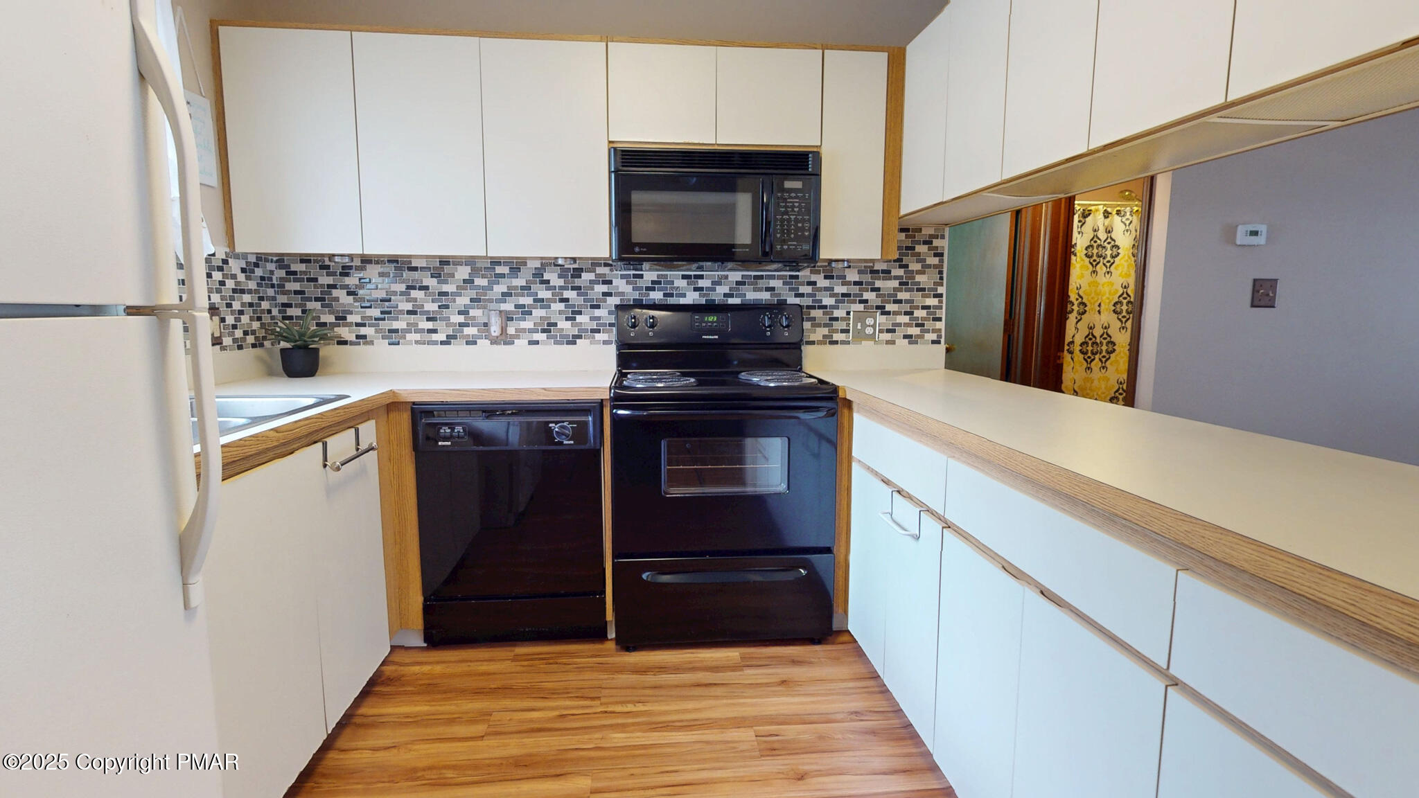 130 Foxfire Drive, Unit 103 Mount Pocono, PA 18344 - Photo 14 of 38 a kitchen with granite countertop a stove and a refrigerator
