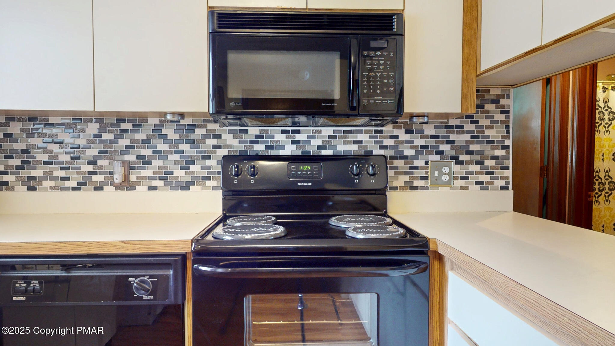 130 Foxfire Drive, Unit 103 Mount Pocono, PA 18344 - Photo 16 of 38 a kitchen with a stove and a microwave