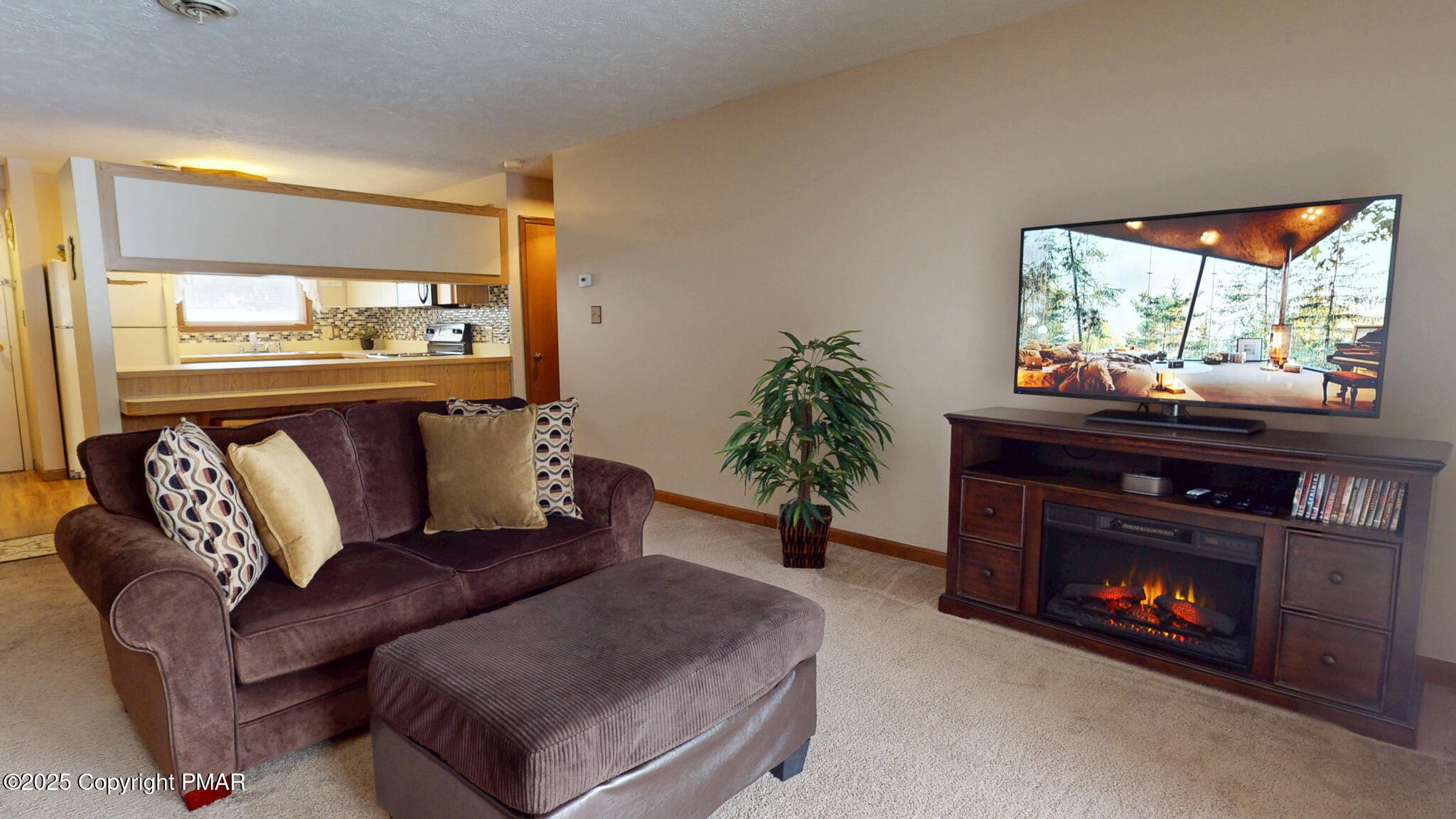 130 Foxfire Drive, Unit 103 Mount Pocono, PA 18344 - Photo 19 of 38 a living room with furniture and a fireplace