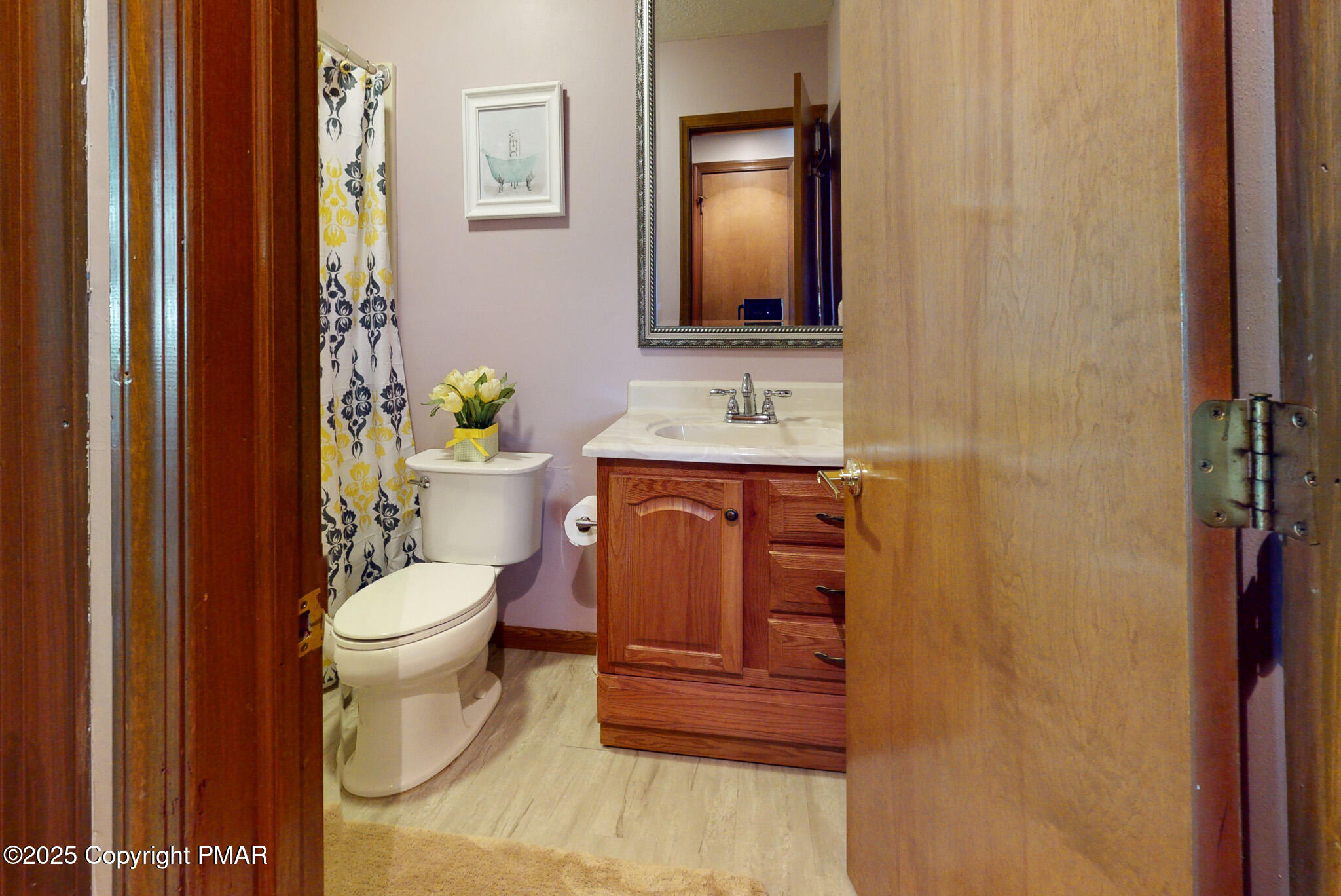 130 Foxfire Drive, Unit 103 Mount Pocono, PA 18344 - Photo 31 of 38 a bathroom with a toilet a sink and mirror