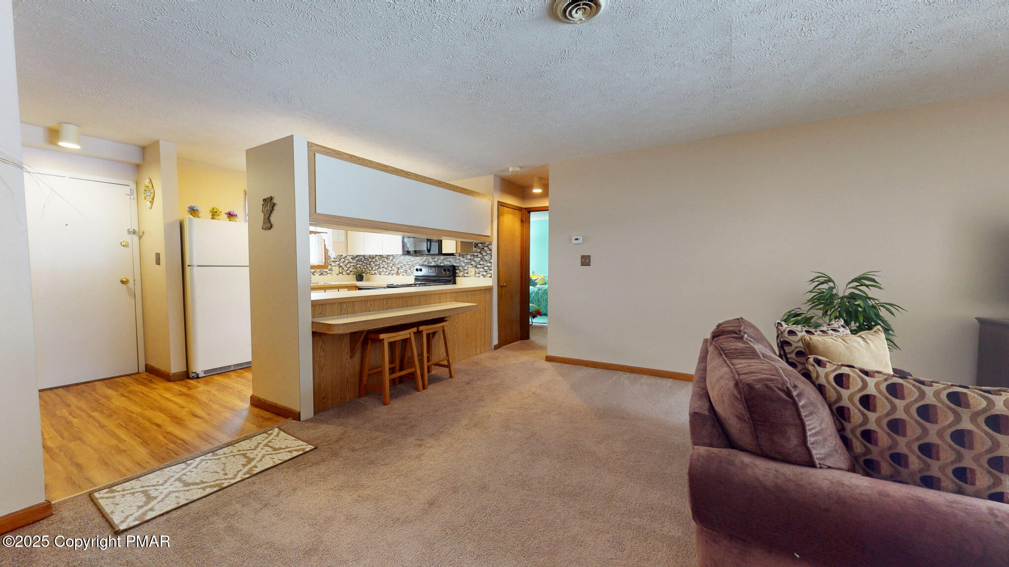 130 Foxfire Drive, Unit 103 Mount Pocono, PA 18344 - Photo 9 of 38 a living room with furniture and a flat screen tv