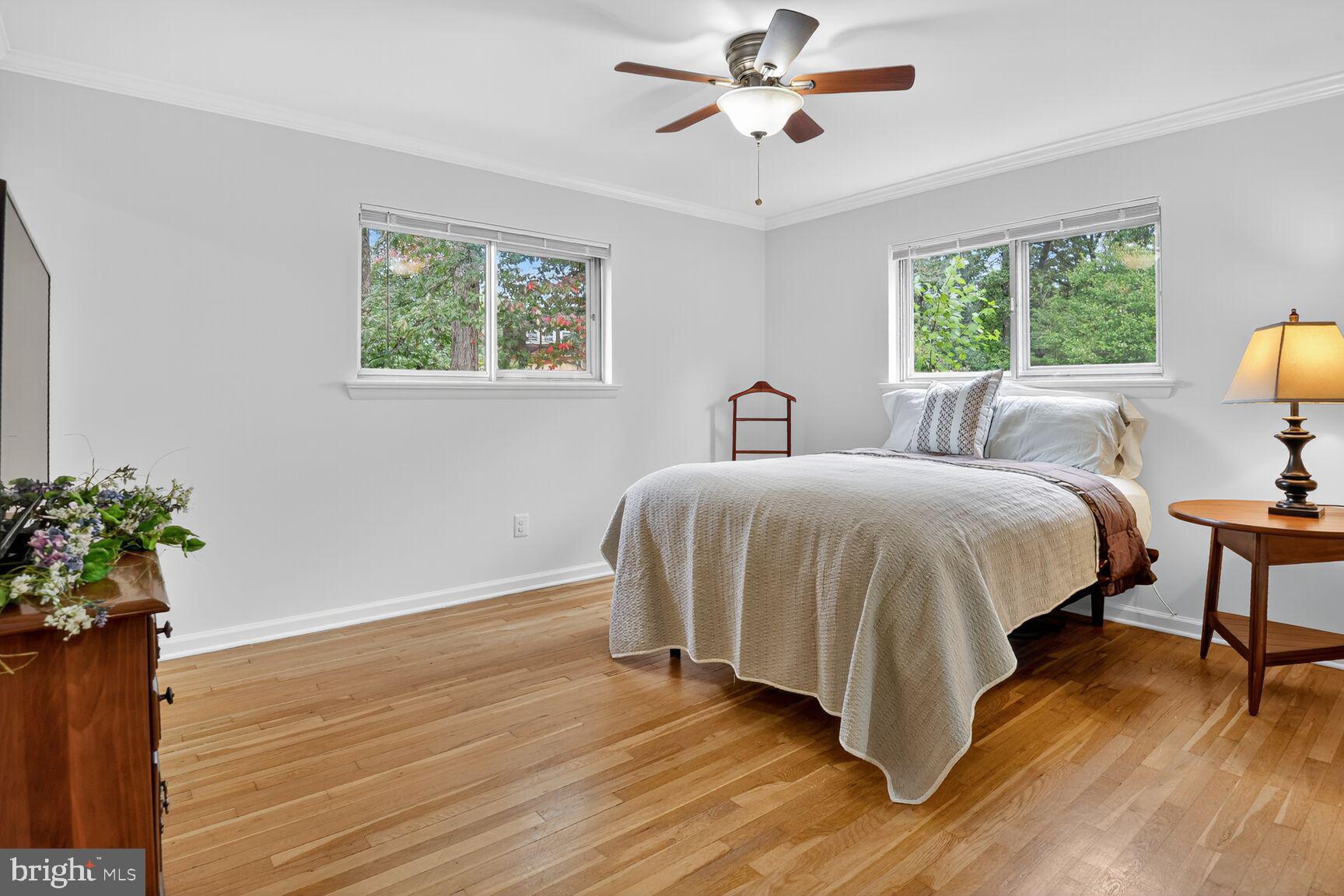 4618 Twinbrook Road Fairfax, VA 22032 - Photo 13 of 24 a bedroom with a large bed chandelier and a window
