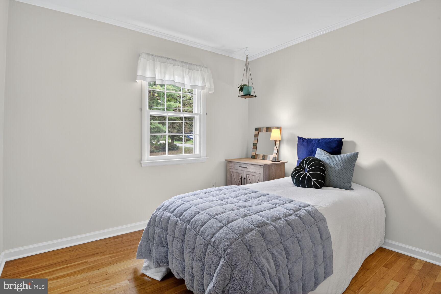 4618 Twinbrook Road Fairfax, VA 22032 - Photo 15 of 24 a bedroom with a bed and wooden floor