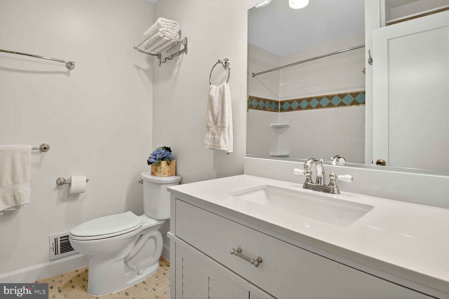 4618 Twinbrook Road Fairfax, VA 22032 - Photo 16 of 24 a bathroom with a sink a toilet and a mirror