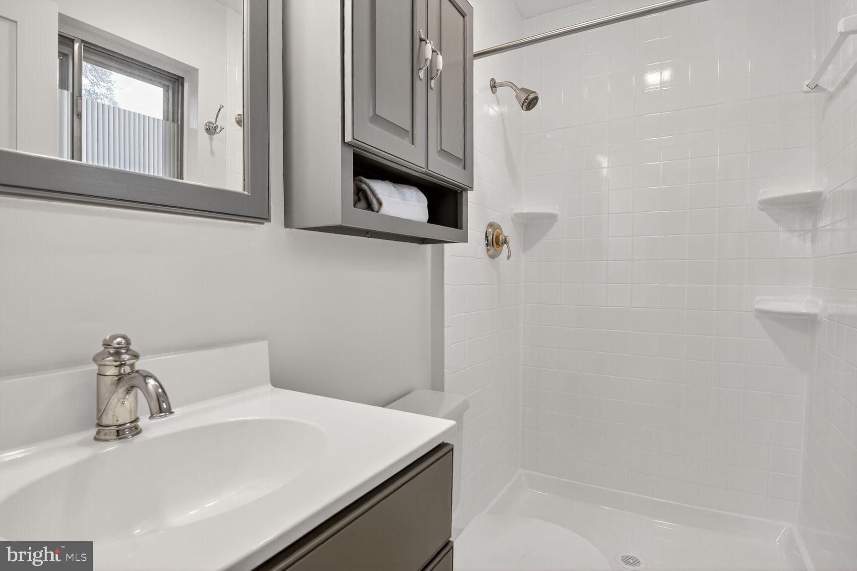 4618 Twinbrook Road Fairfax, VA 22032 - Photo 17 of 24 a bathroom with a sink a vanity and a mirror