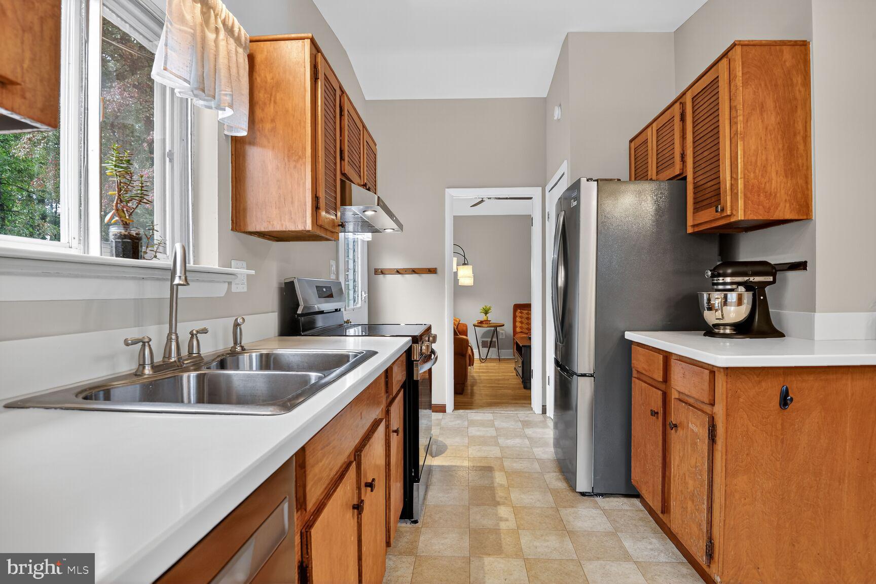 4618 Twinbrook Road Fairfax, VA 22032 - Photo 6 of 24 a kitchen with stainless steel appliances a sink and a refrigerator
