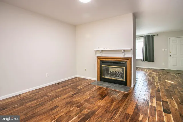 a view of an empty room and wooden floor