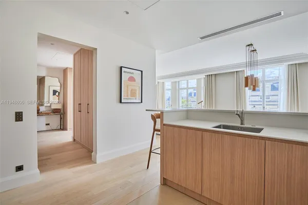 a spacious bathroom with a granite countertop sink a mirror and a bathtub