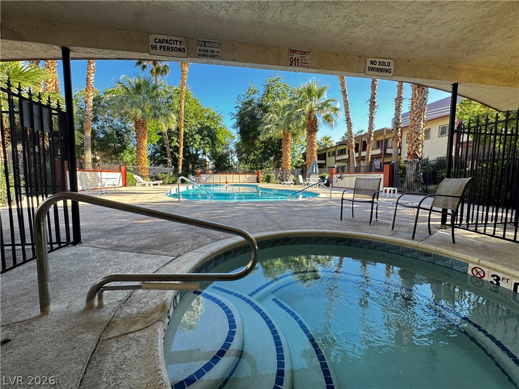 350 East Desert Inn Road, Unit C103 Las Vegas, NV 89109 - Photo 3 of 23 An inviting community pool and spa area, perfect for relaxation and recreation.