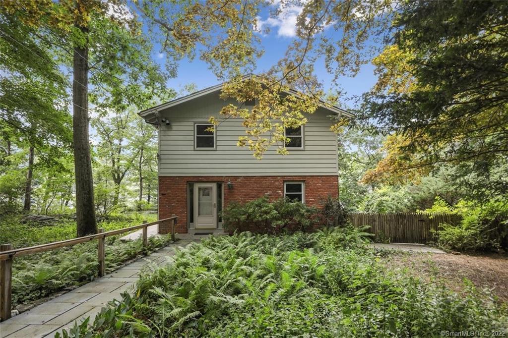 2 Craigmoor Road North Ridgefield, CT 06877 - Photo 1 of 1 a view of a house with a small yard and a large tree
