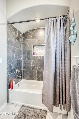 a bedroom with a bed and a lamp