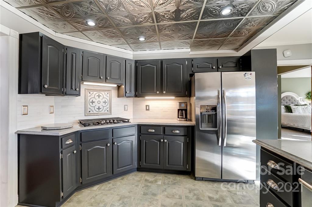 1517 Helms Shortcut Road Monroe, NC 28112 - Photo 12 of 45 a kitchen with stainless steel appliances granite countertop a sink stove and refrigerator