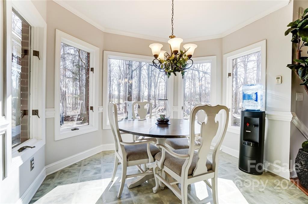 1517 Helms Shortcut Road Monroe, NC 28112 - Photo 13 of 45 a dining room with furniture a chandelier and window