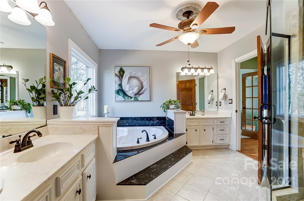 1517 Helms Shortcut Road Monroe, NC 28112 - Photo 17 of 45 a spacious en suite bathroom with a double vanity sink a mirror and a bathtub