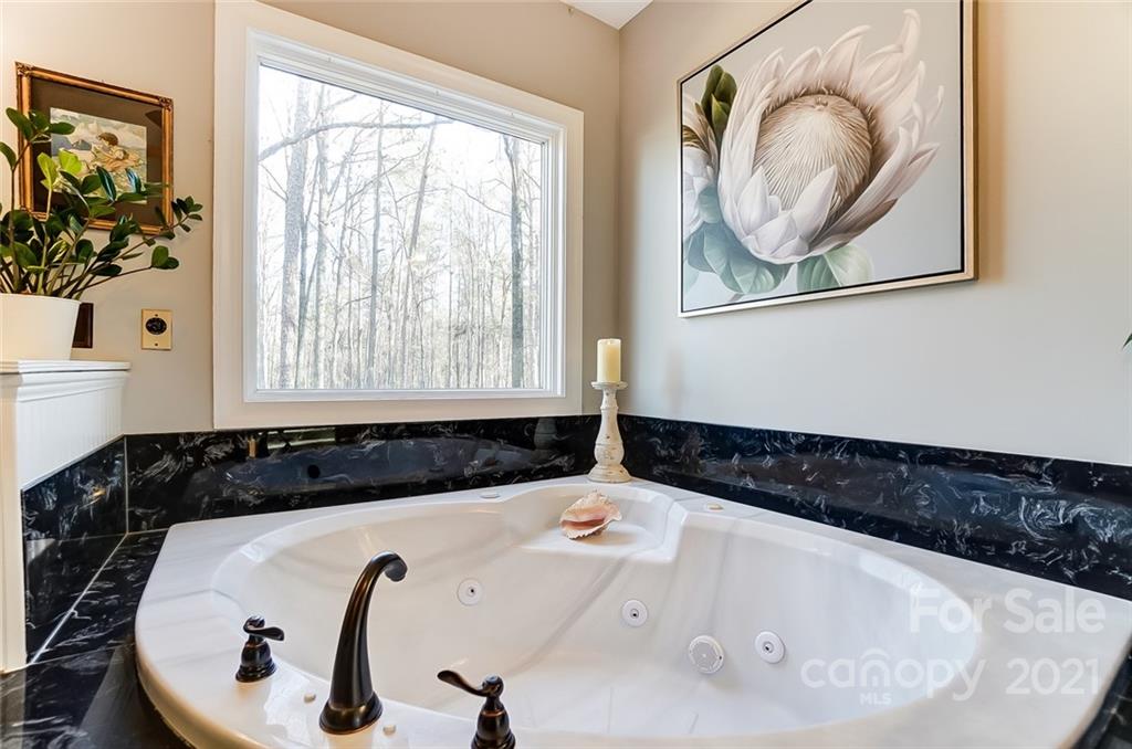 1517 Helms Shortcut Road Monroe, NC 28112 - Photo 18 of 45 a bathroom with a bathtub and a window