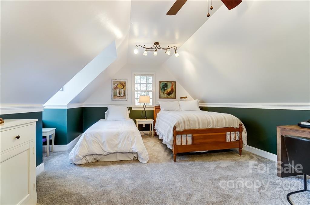 1517 Helms Shortcut Road Monroe, NC 28112 - Photo 24 of 45 a spacious bedroom with a bed and a chandelier