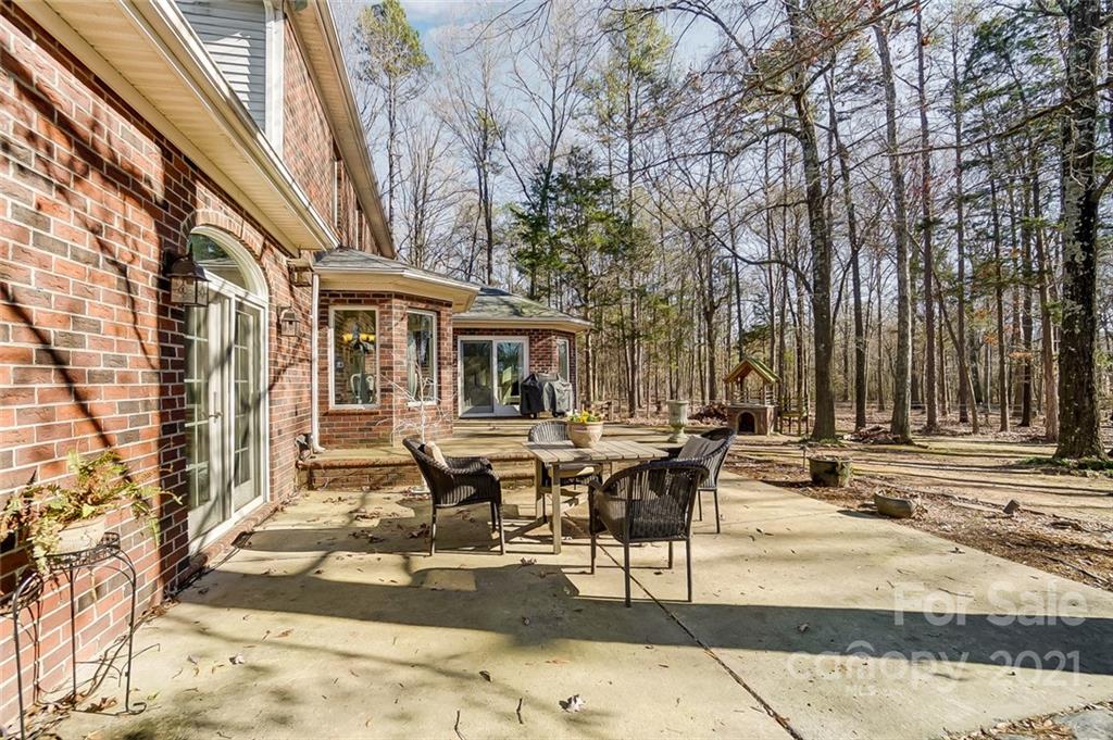 1517 Helms Shortcut Road Monroe, NC 28112 - Photo 29 of 45 a backyard of a house with barbeque oven table and chairs