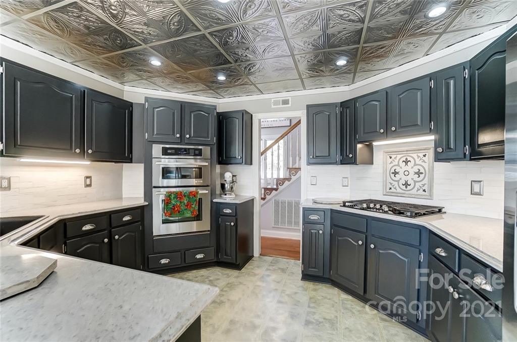 1517 Helms Shortcut Road Monroe, NC 28112 - Photo 9 of 45 a kitchen with a stove sink and a microwave