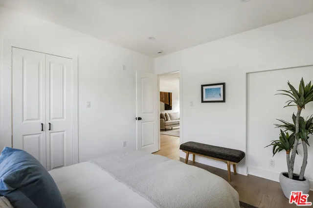a bedroom with furniture and a potted plant