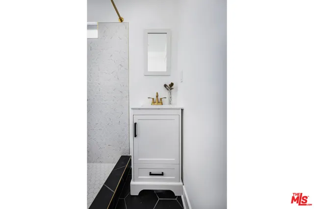 a bathroom with a sink a mirror and a bathtub