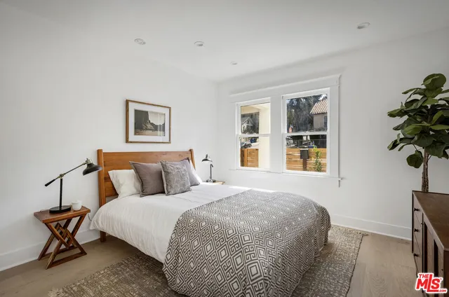 a bedroom with bed and window