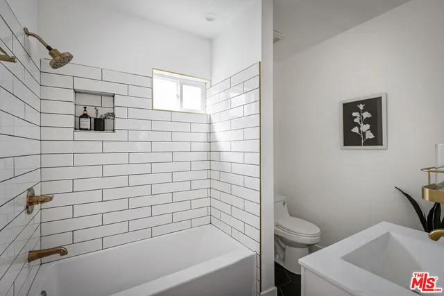 a bathroom with a bathtub and toilet