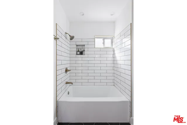 a bathroom with a bathtub and shower