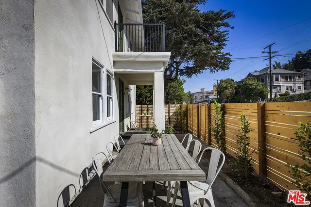 a view of a patio with two chairs and a table