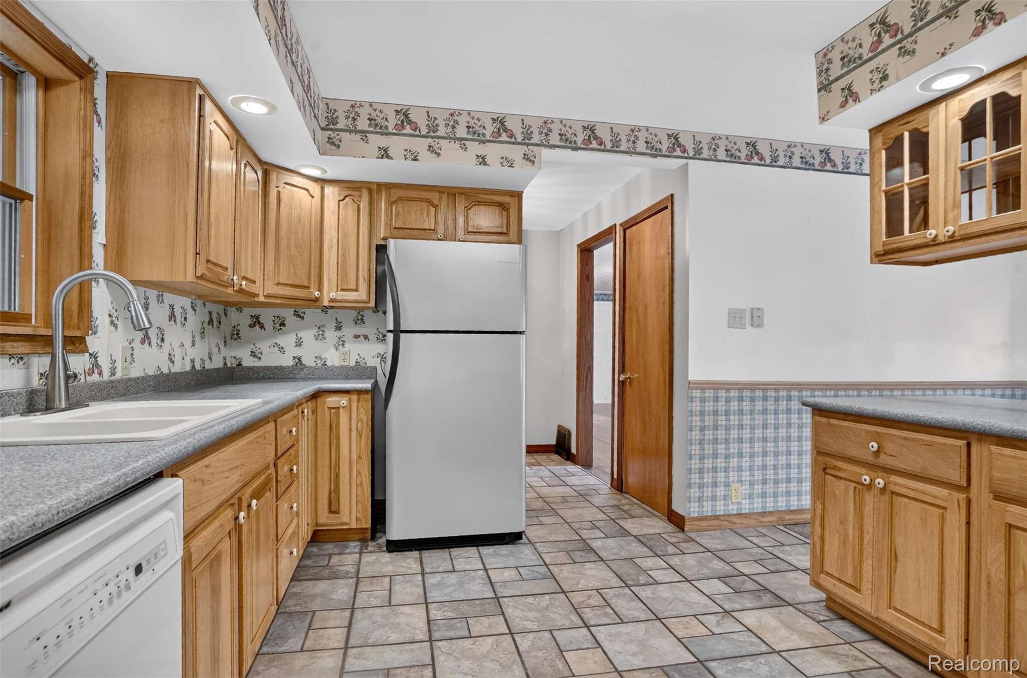 1437 East Cook Road Grand Blanc, MI 48439 - Photo 47 of 69 Kitchen featuring wood cabinetry, recessed lighting, and a double basin sink with a gooseneck faucet