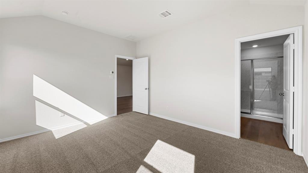 1663 Blaire Drive Tyler, TX 75704 - Photo 16 of 26 Carpeted room with vaulted ceilings and white walls