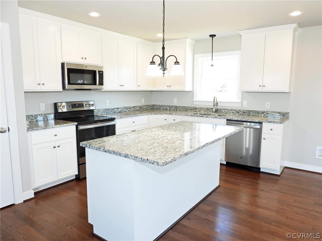 4608 Pin Oak Road Prospect, VA 23960 - Photo 1 of 29 a large kitchen with granite countertop a sink and a stove top oven with wooden floor