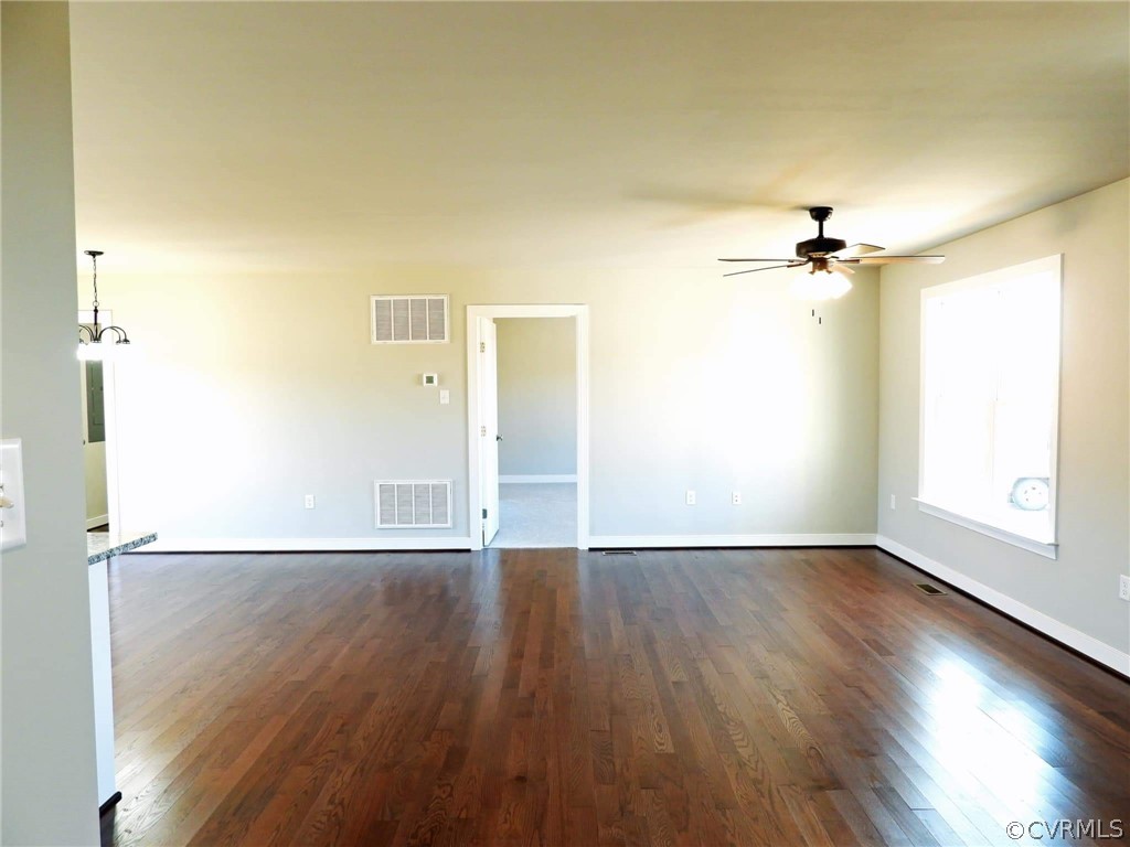 4608 Pin Oak Road Prospect, VA 23960 - Photo 12 of 29 an empty room with wooden floor fan and windows