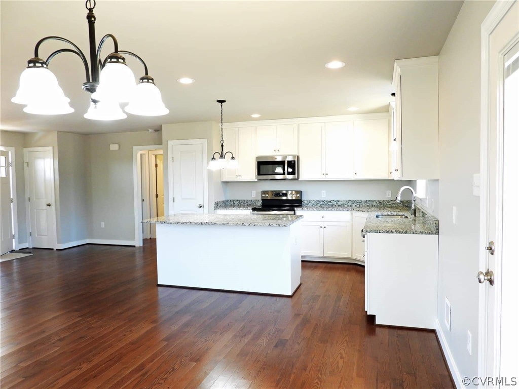 4608 Pin Oak Road Prospect, VA 23960 - Photo 7 of 29 a kitchen with kitchen island white cabinets with wooden floor and stainless steel appliances