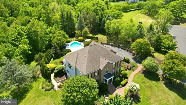 an aerial view of a house with yard and outdoor seating