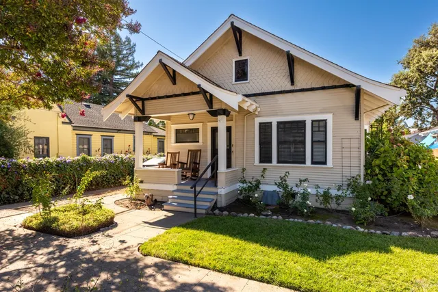 a view of a house with backyard sitting area and garden