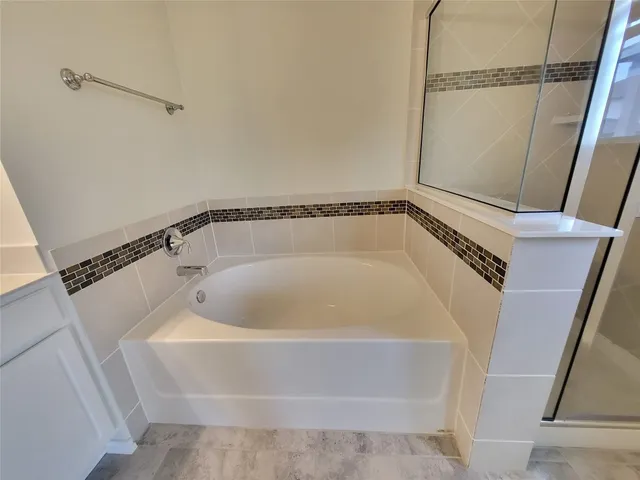 a bathroom with a window and a shower