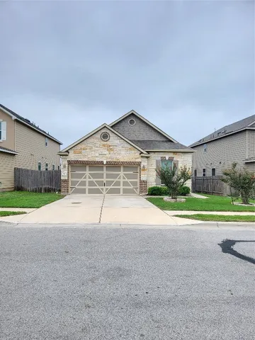 a view of an house with a yard and garage