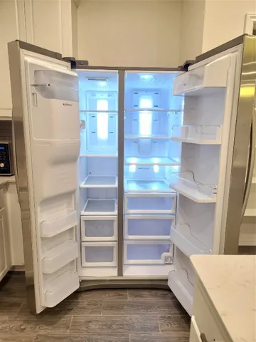 a view of walk in closet with empty racks