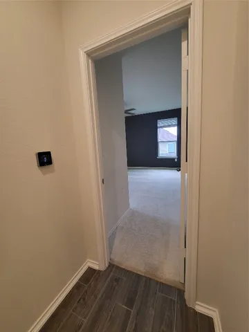 a view of empty room with wooden floor and cabinet