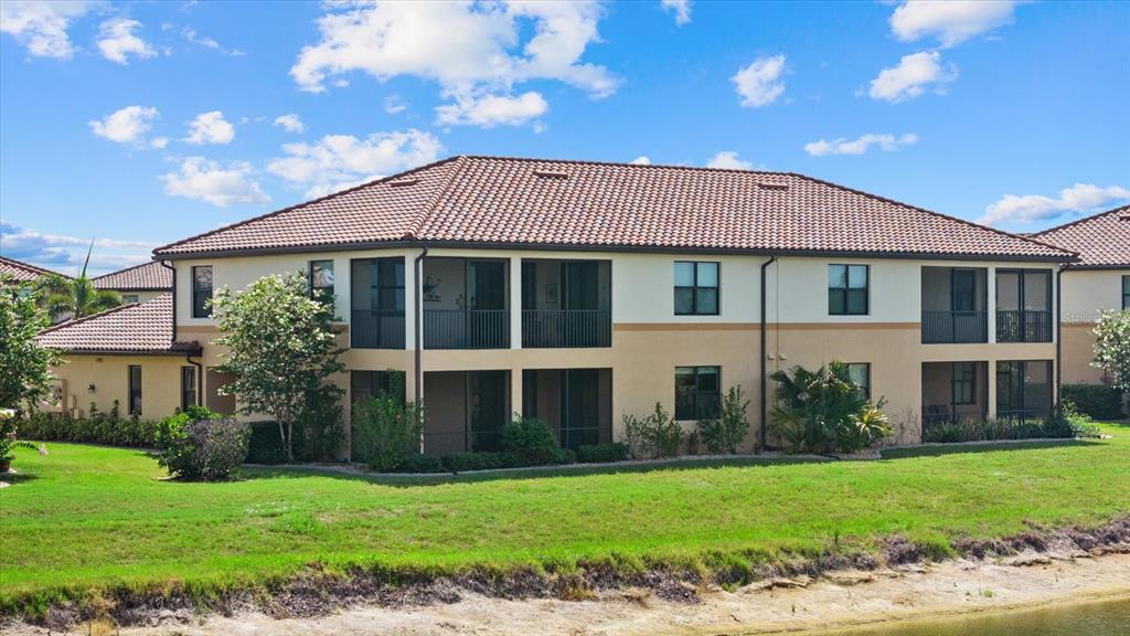 20080 Ragazza Circle, Unit 102 Venice, FL 34293 - Photo 11 of 49 a view of a house with a yard