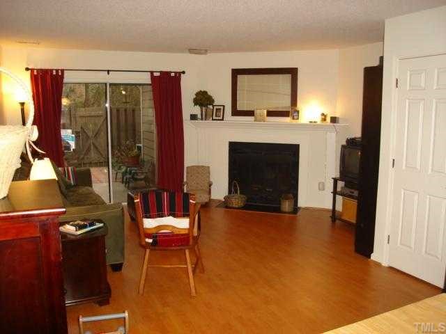 2215 Alpine Road Durham, NC 27707 - Photo 2 of 7 Nice open living room with new flooring and corner fireplace.